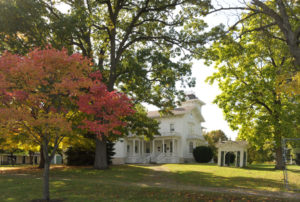 white fond du lac mansion surrounded by trees